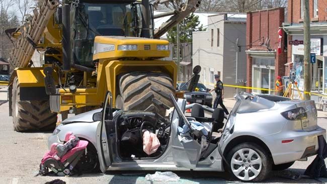 A nine year old girl was killed when the car she was a passenger in collided with fertilizer sprayer on Main St. in Otterville, Ont. on Sunday, May 11, 2014. DEREK RUTTAN/QMI Agency