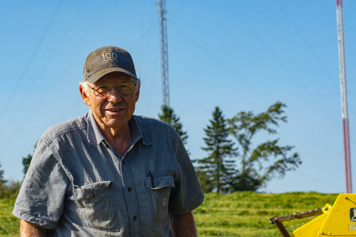 Perry Lilley, co-owner of Lilley Farms in Smyrna takes a break from topping off hay on Thursday. The farm will stop producing milk the end of the month. Credit: Kathleen Phalen Tomaselli / Houlton Pioneer Times